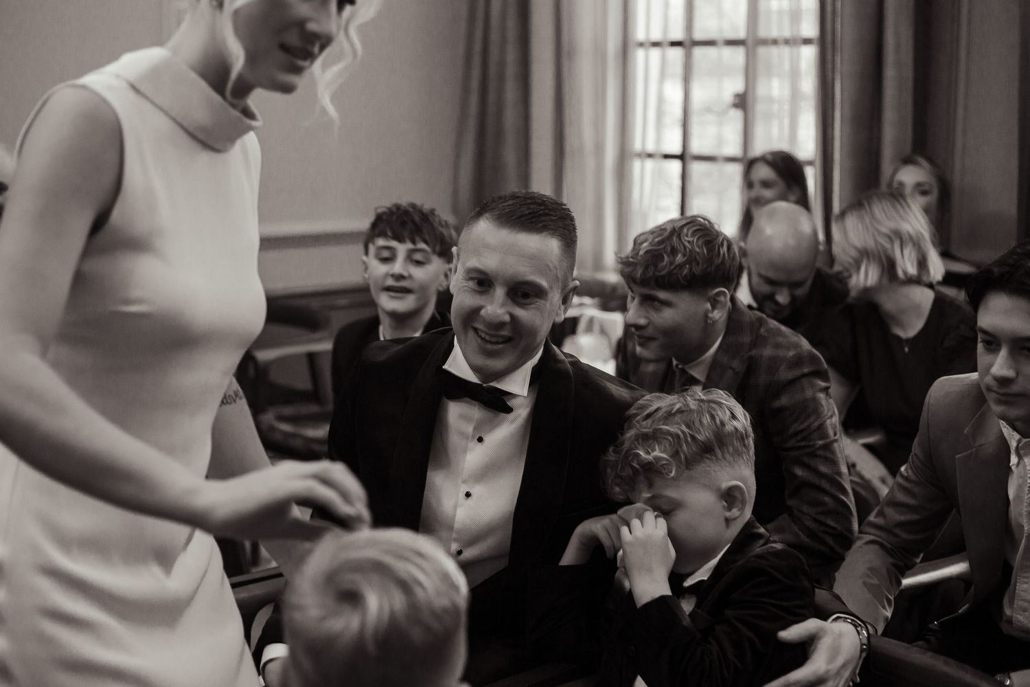 the bride and bestman comfort the bride's son as he is overcome with emotion watching his parents get married at old marylebone town hall