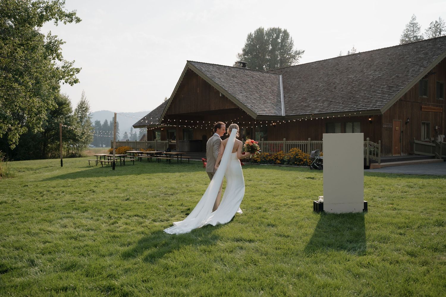 A series of panoramic shots showing a rustic barn venue and grassy field with wedding decor set up.