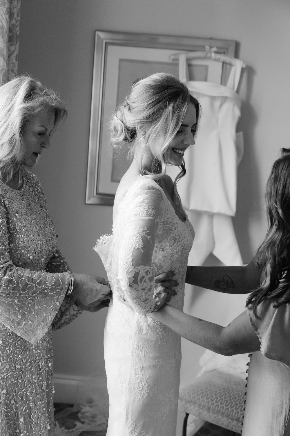 Black and white photo showing sparkly dresses and wedding preparations in a dressing room.