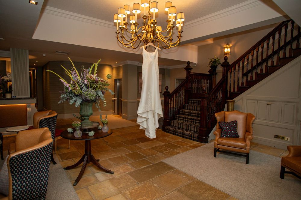 Elegant foyer with wooden staircase, chandelier, and traditional decor showcasing a grand entrance design.