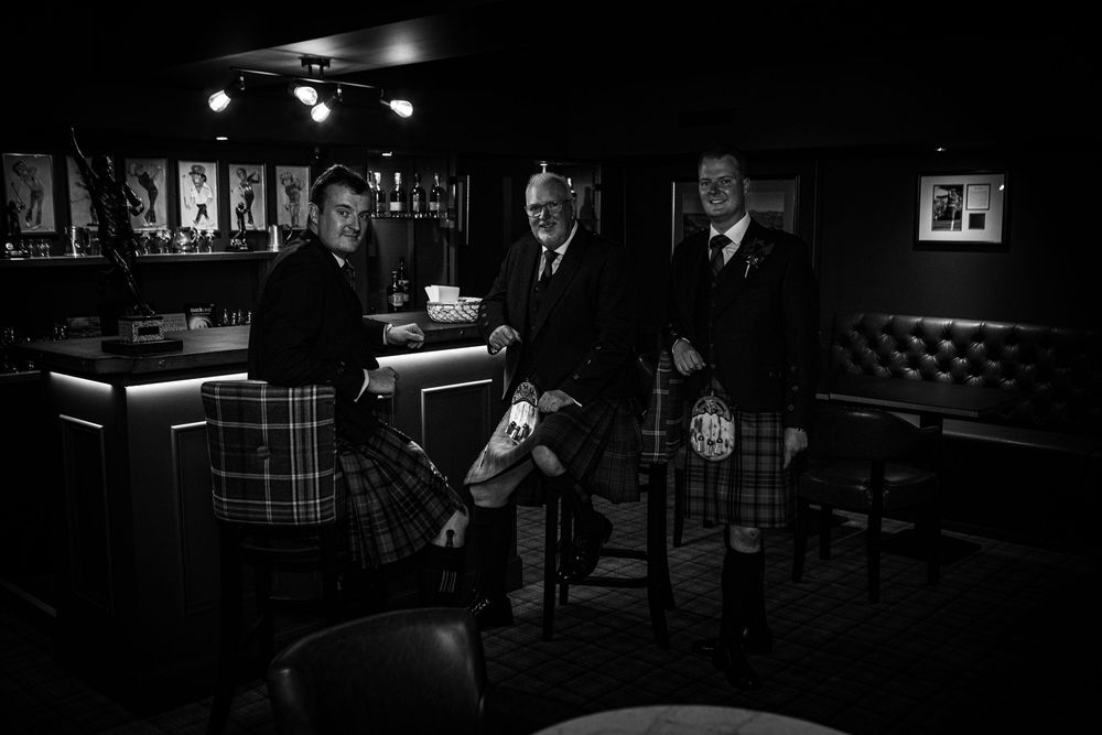 Film noir scene showing a dark, moody interior with dramatic lighting and vintage furniture.