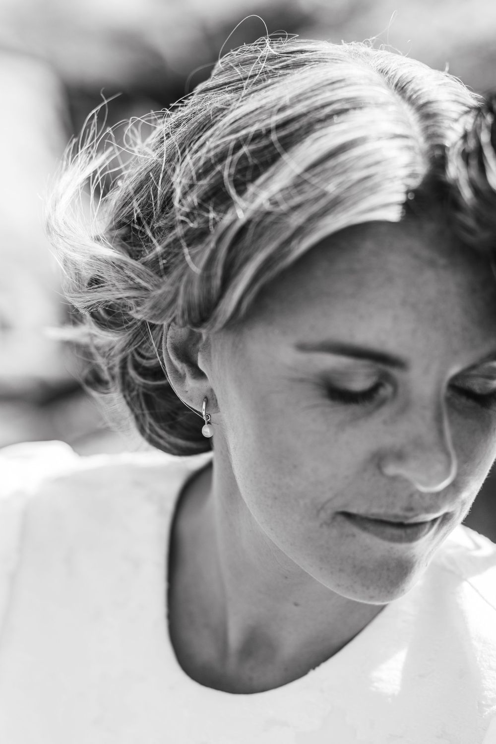 A series of black and white profile portraits showing different emotional expressions with windswept hair.