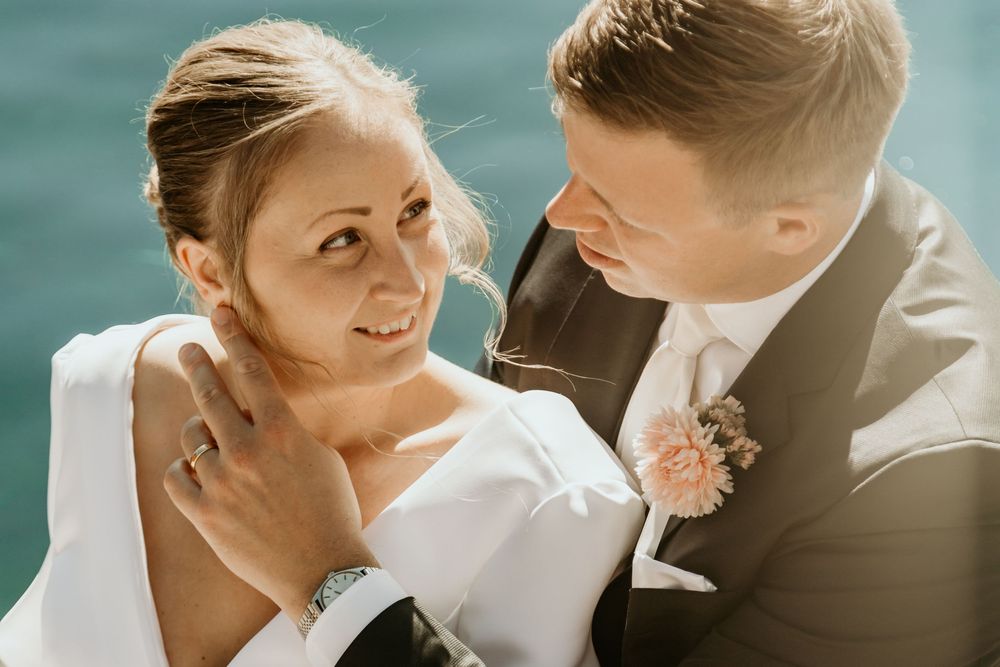 Romantic wedding couple shares intimate moments in a series of close-up shots against a blurred teal background.