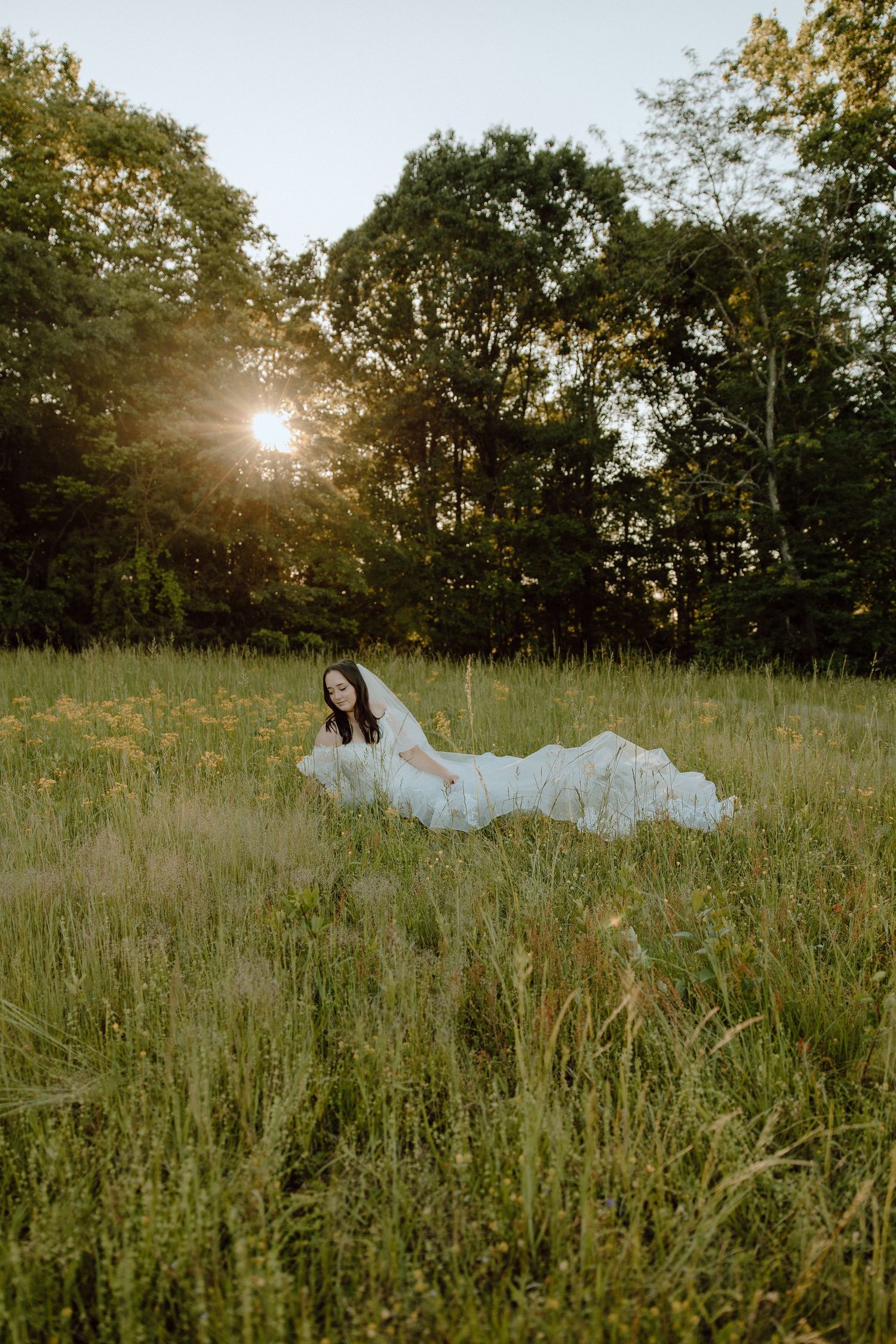 Dreamy bridal portrait in a wildflower meadow at golden hour.