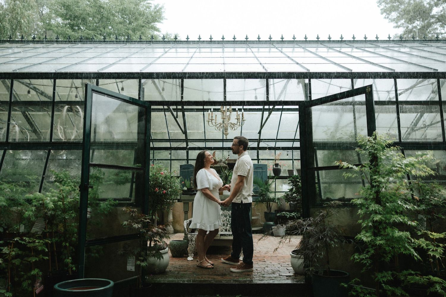 Couple pose inside greenhouse at Peconic River Herb Farm on Long Island