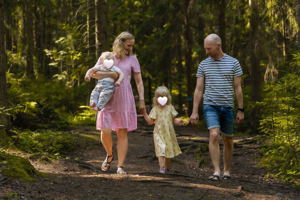Family walking together on forest trail during outdoor adventure.