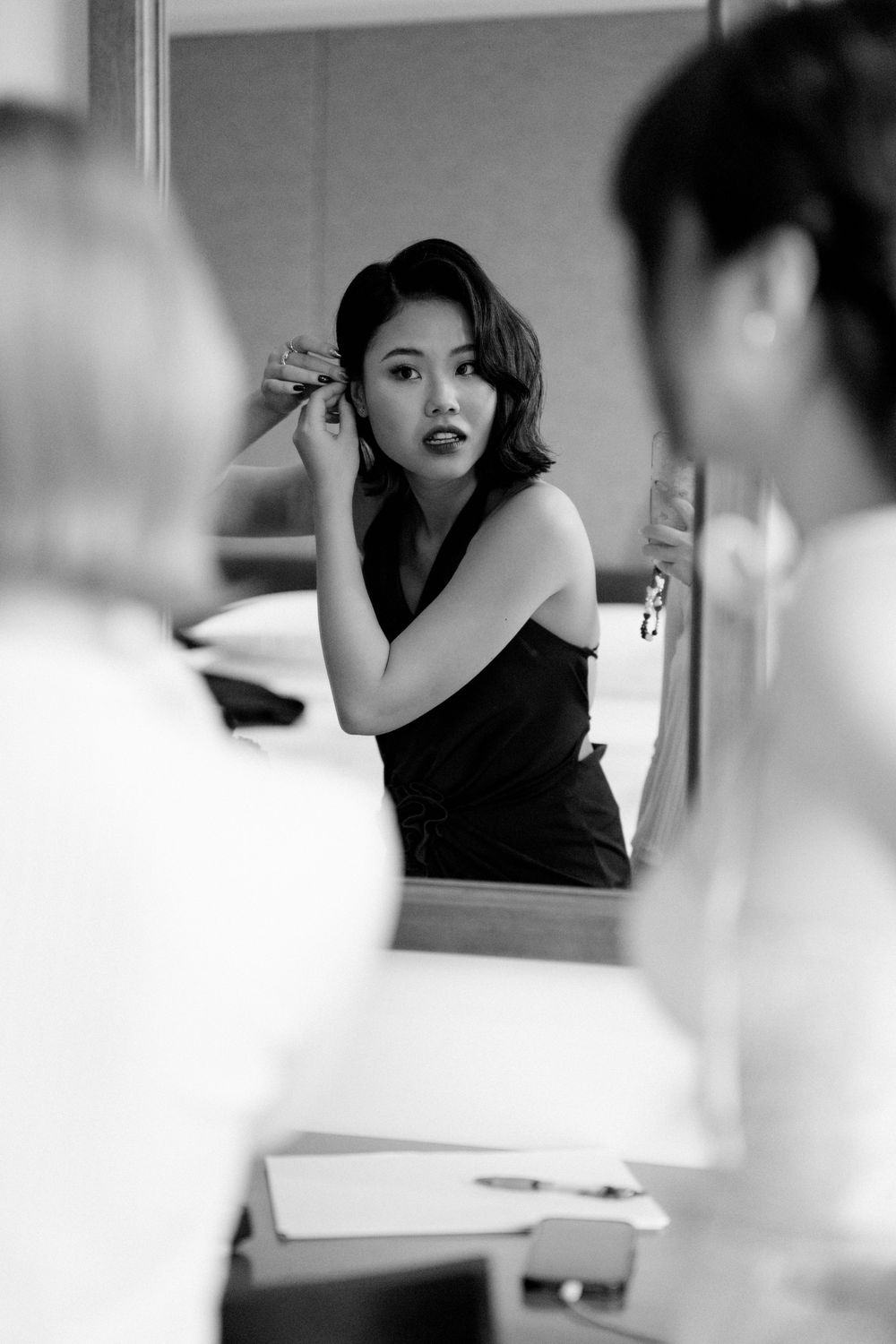Artistic black and white portrait shot showing a glamorous retro-inspired makeup look and styling.