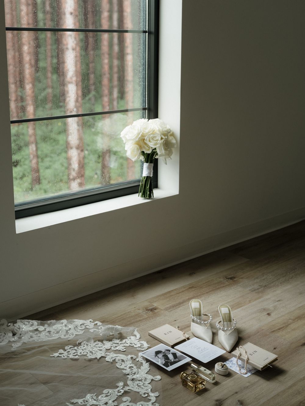 Rustic window sill with scattered objects and natural light streaming in from a forest view.