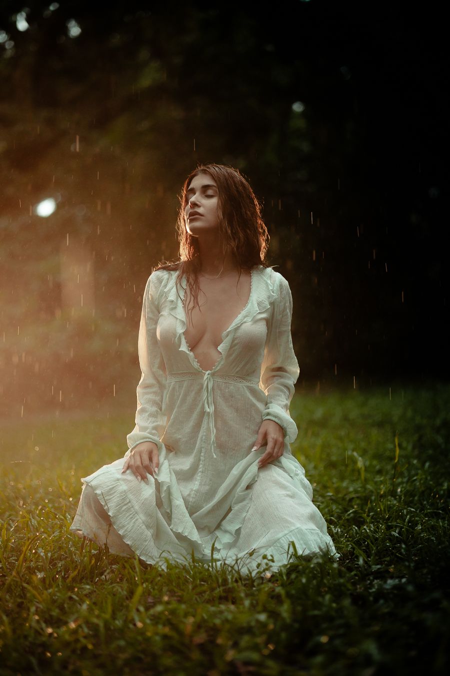 Romantic Vogue-style portrait in Miami Beach park, woman kneeling in white dress with Chanel-inspired timeless fashion. By MannyPortraits.