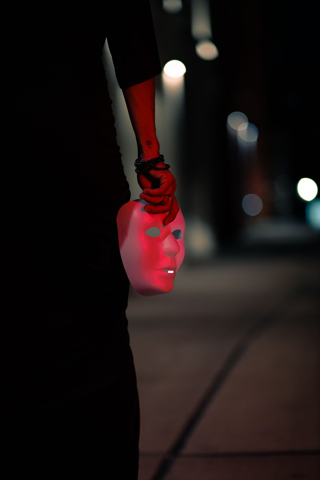 Editorial South Florida portrait with glowing red mask, dramatic cinematic style inspired by Gotham films. MannyPortraits.”