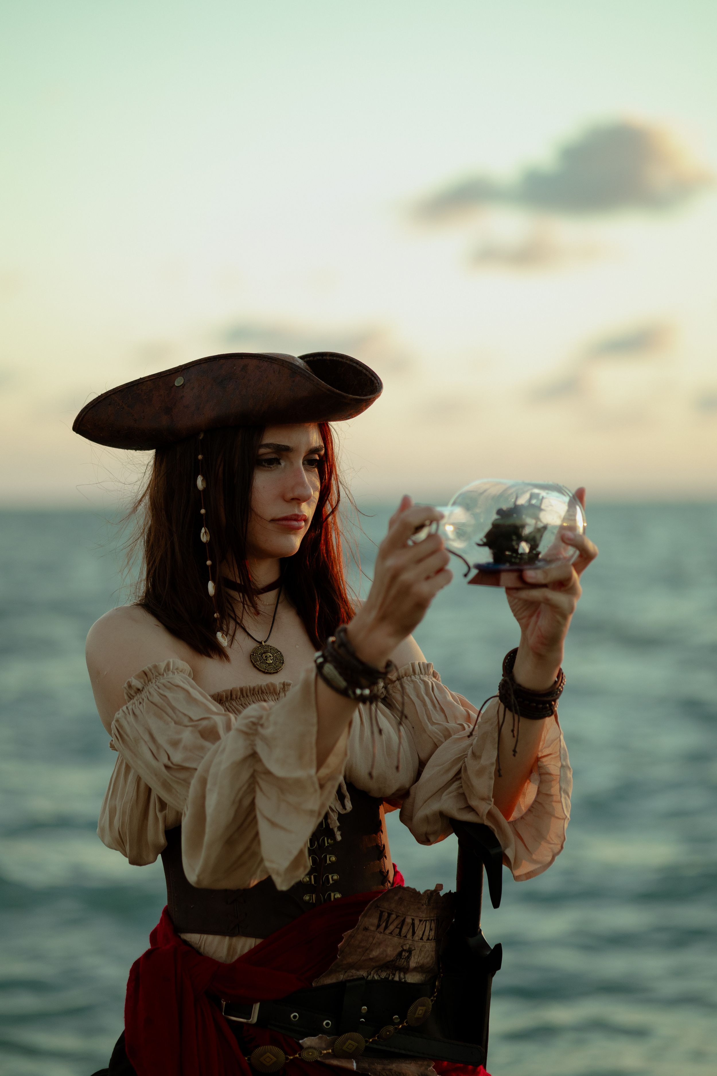 Model on rocky coastline, pirate-themed fashion editorial, South Florida ocean backdrop, Mannyportraits cinematic photography for actors.