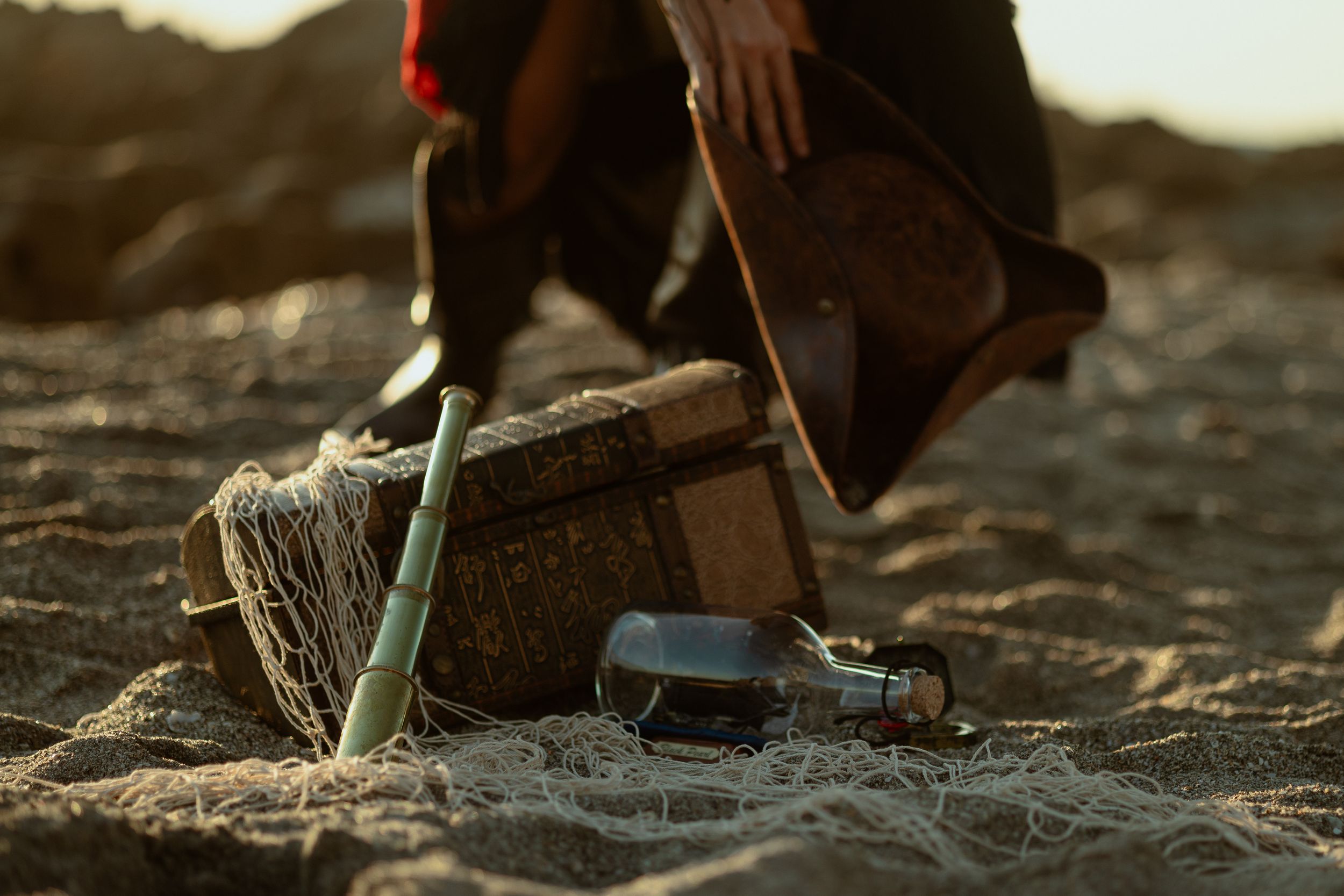 Treasure chest props styled on sand, cinematic flatlay, Miami cosplay photography for actors & performers, Mannyportraits storytelling.