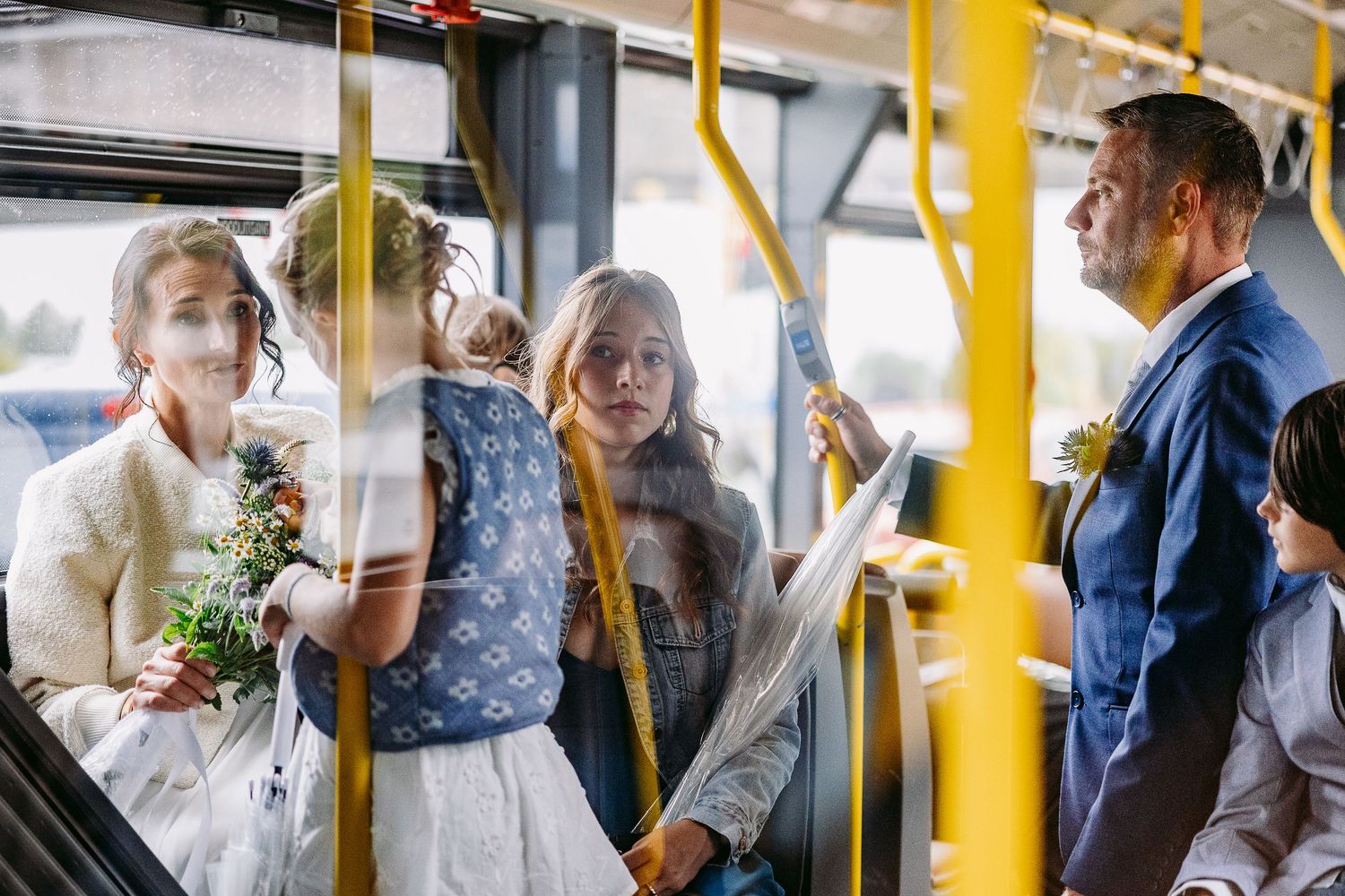 A sequence of images shows a bride and groom riding a public bus with yellow handrails while sharing tender moments together.