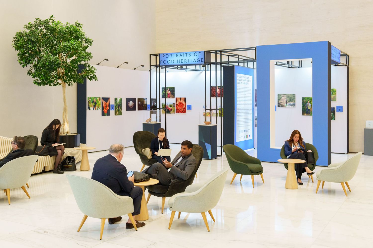 Photography exhibition space with people seated around