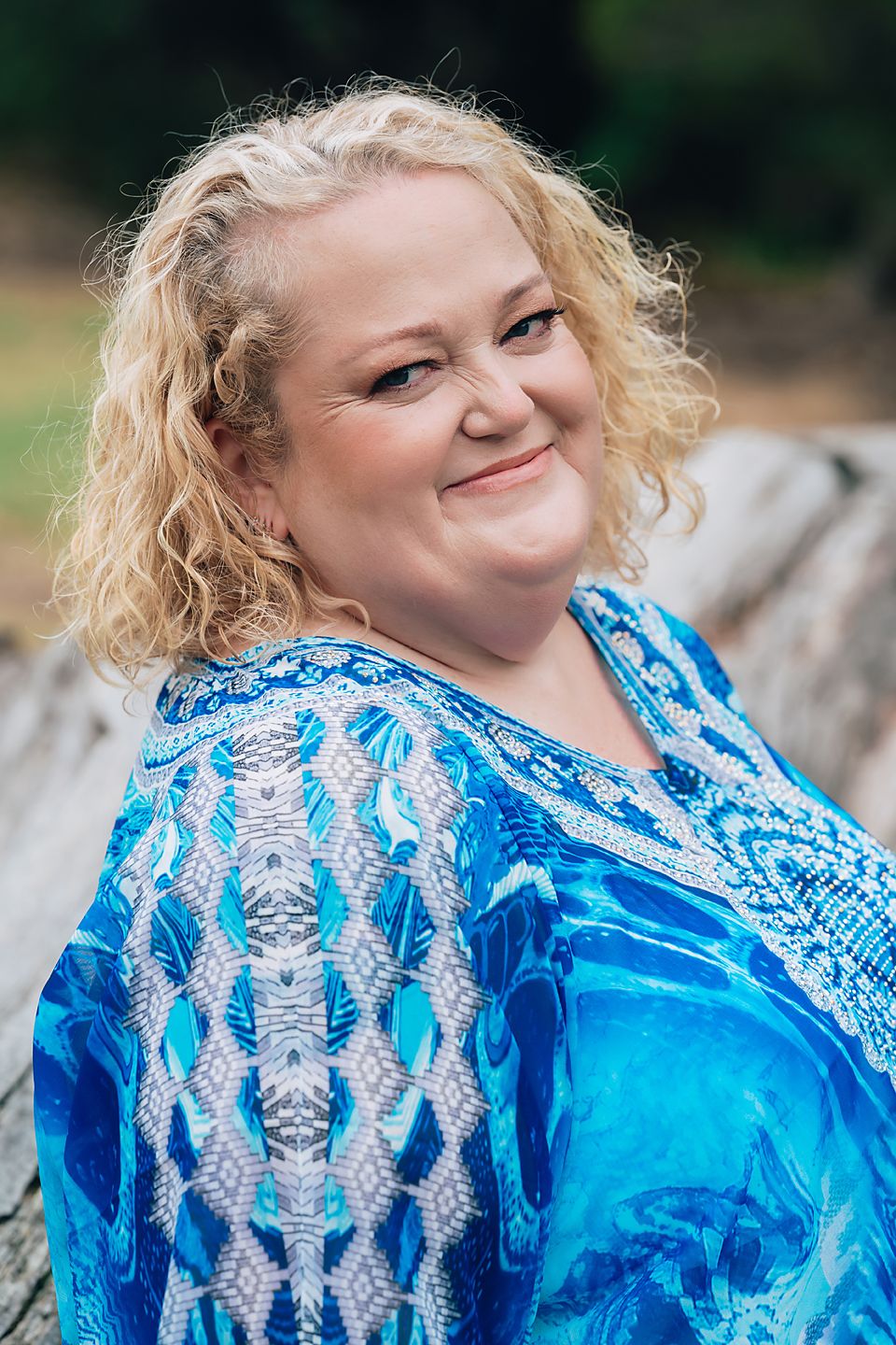 A series of close-up shots showing a vibrant blue and white patterned kaftan blowing in the breeze outdoors.