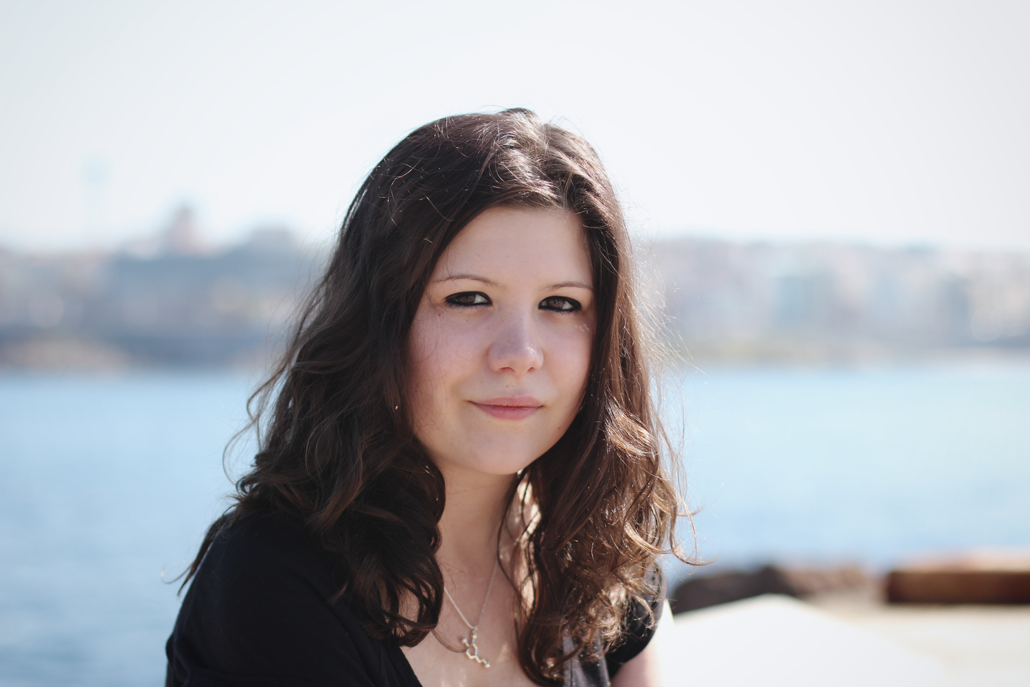 Small business branding photoshoot. Professional outdoor portrait with waterfront backdrop and natural lighting.