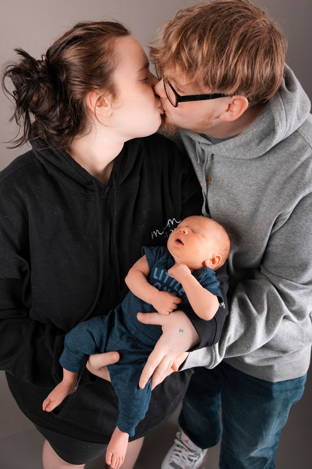 A series of loving moments between parents and their infant, showing tender kisses and embraces in color photography.