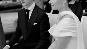 Elegant black and white portrait capturing intimate wedding ceremony moment.