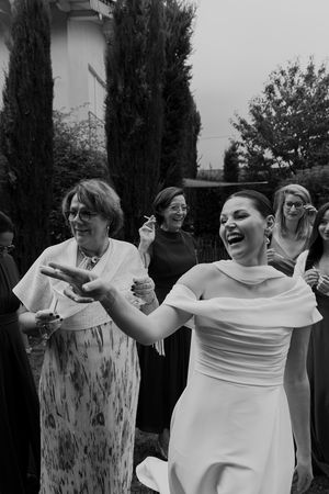 Wedding guests enjoying a celebratory moment in a garden setting.