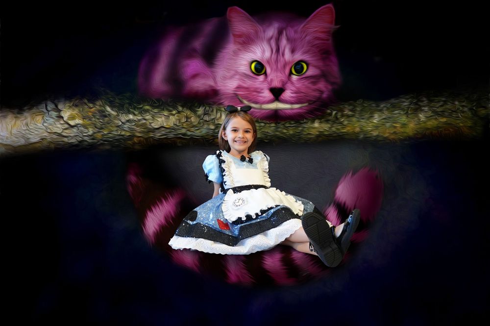 A purple Cheshire Cat stuffed toy with glowing blue eyes and signature grin photographed in a dark setting.