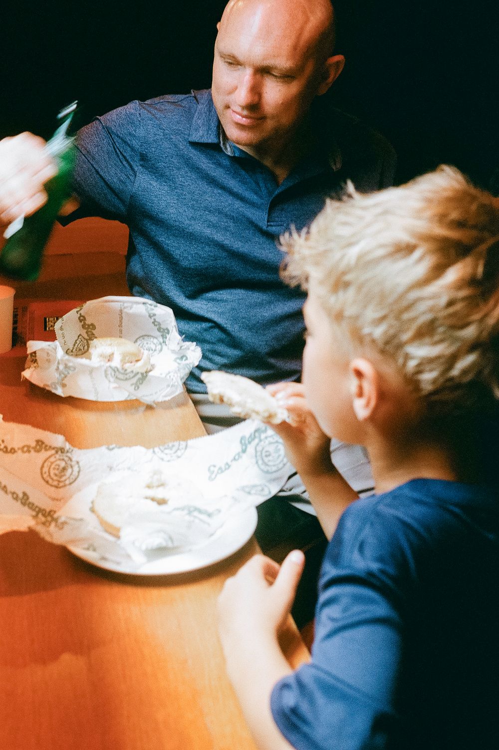 Multiple similar images showing a child and adult coloring together at a table with blank white paper in front of them.