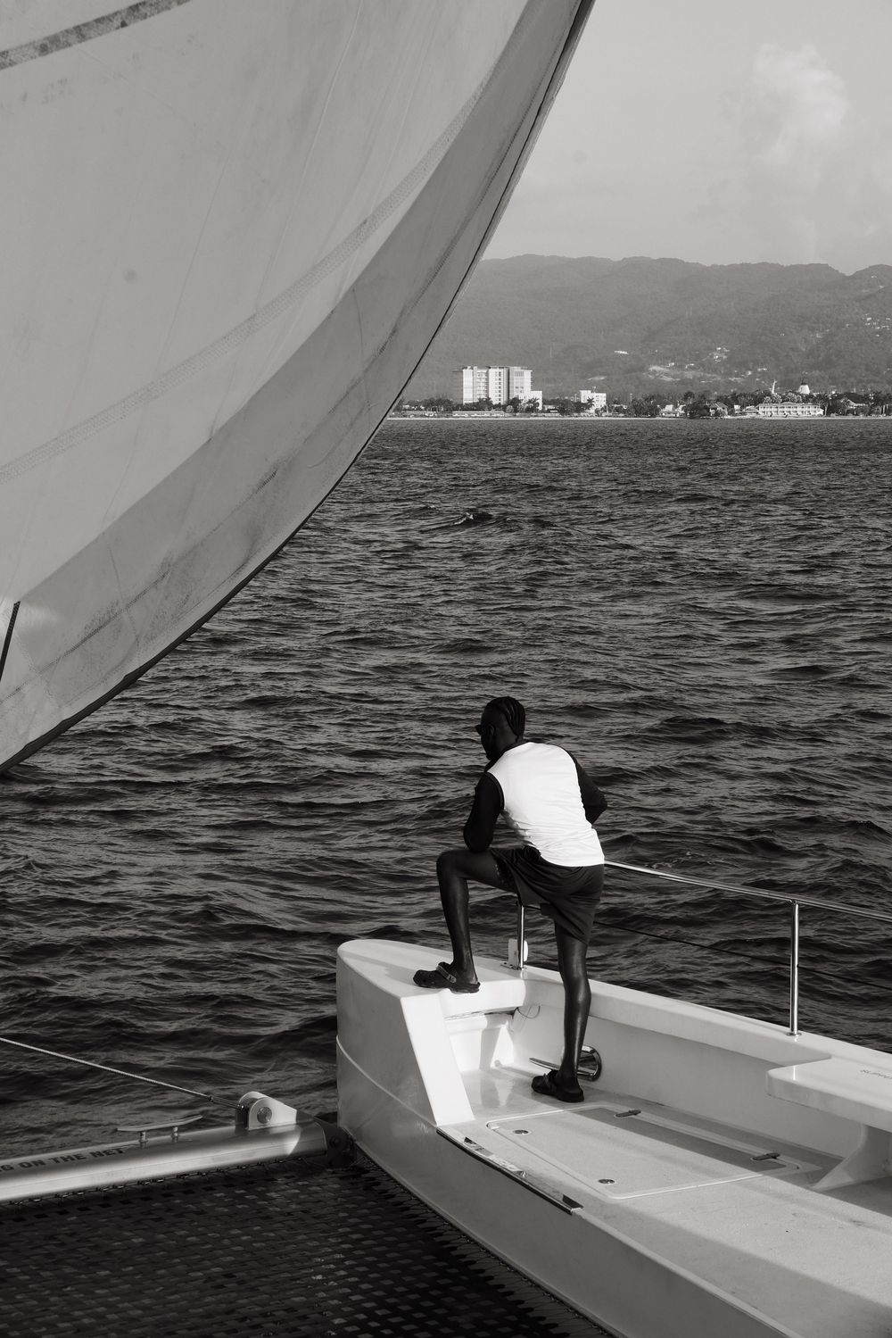 A five-panel sequence showing a person sailing a small boat on dark waters with mountains visible in the distance.