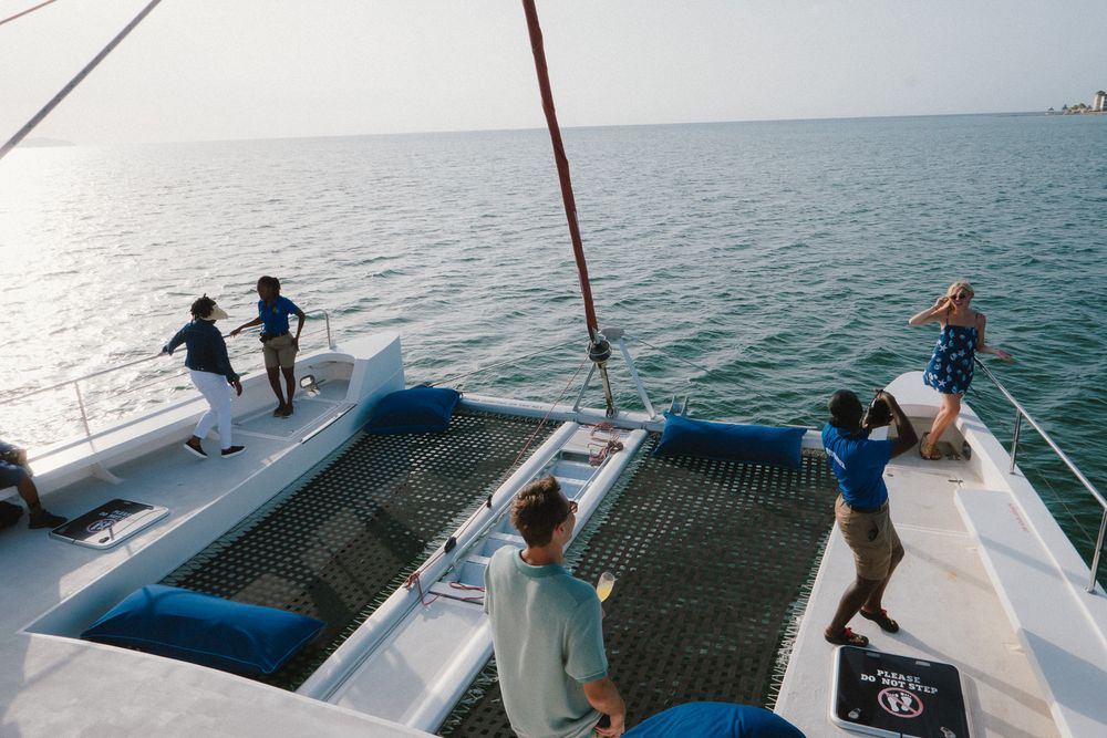 A sequence showing people pulling a boat out of the water onto a dock using ropes and teamwork.