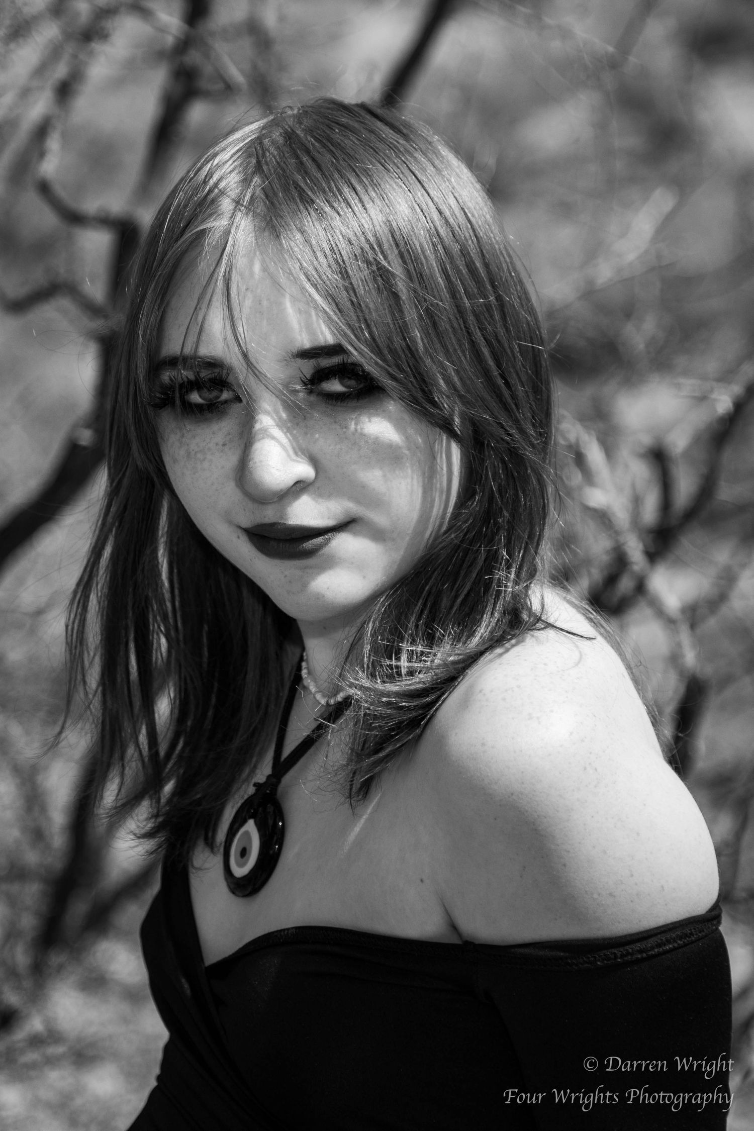 Artistic black and white portrait series featuring dramatic lighting and makeup.