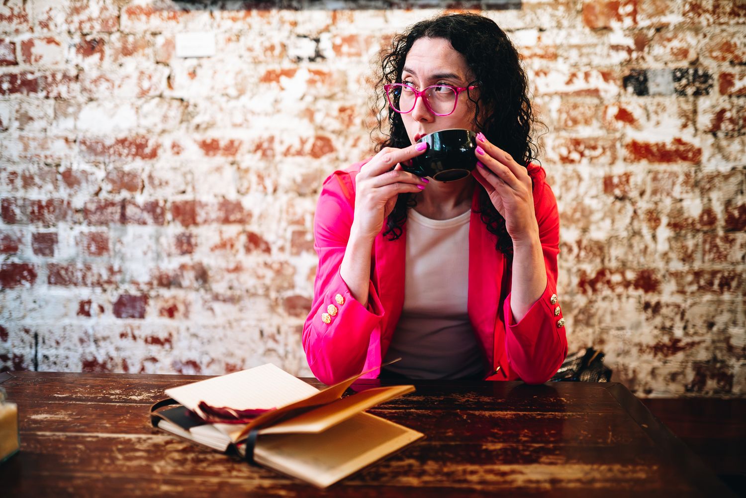 Melbourne branding photo of a writer in pink blazer drinking coffee at Krimper Cafe, perfect for lifestyle photography.