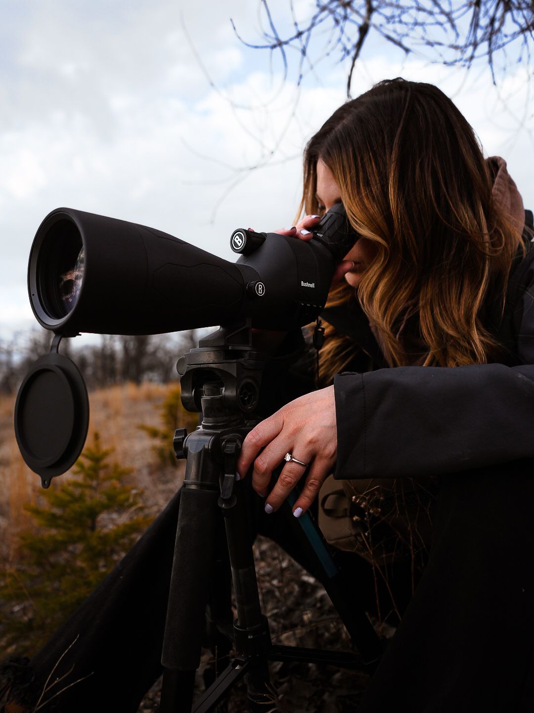 Side view of spotting scope mounted on tripod being used for wildlife observation.
