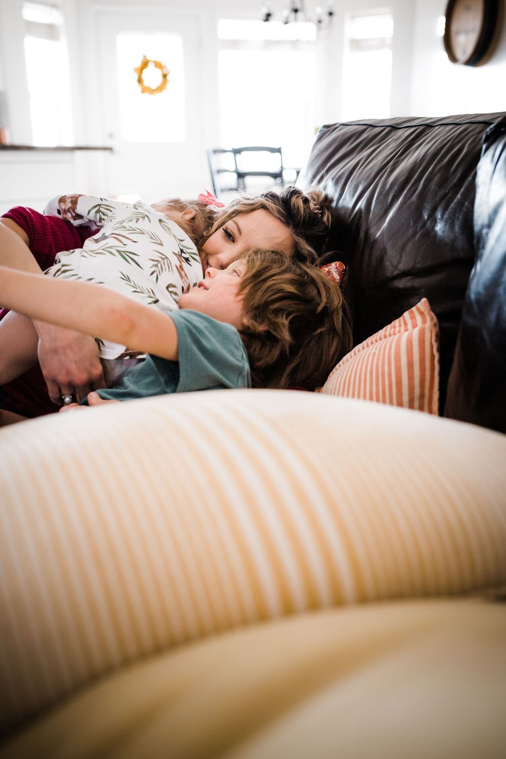 Peaceful moment of relaxation on a cozy striped couch with soft pillows in natural lighting.
