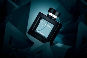 Jivago Tuxedo men's cologne bottle floating against a dark teal geometric background.