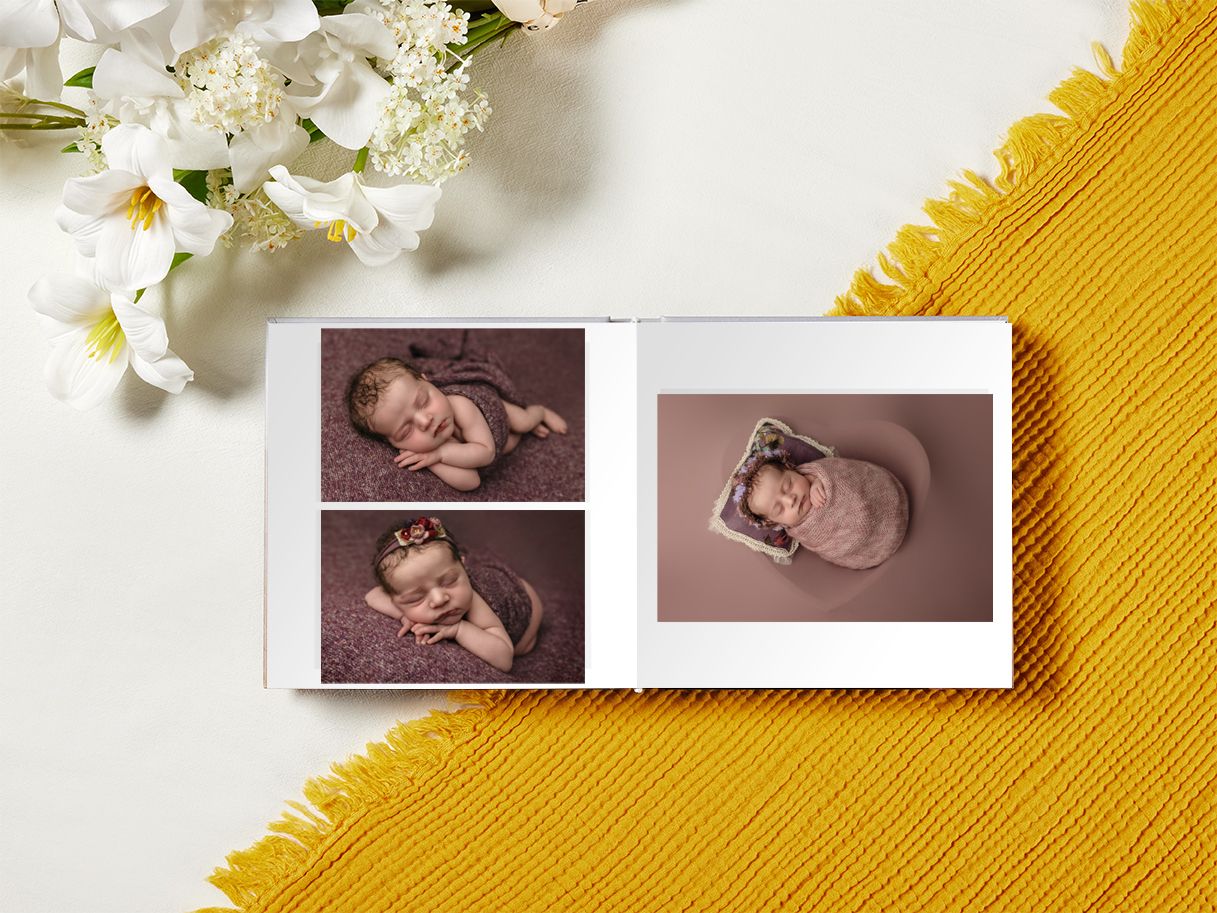 Fine art album featuring purple-hued newborn girl photos taken by Somerset Portraits, a Charlottesville family and baby photographer.