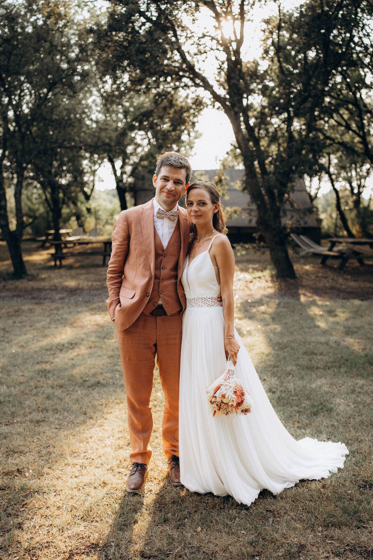 A tender autumn embrace captured during a wedding photoshoot with fall foliage.