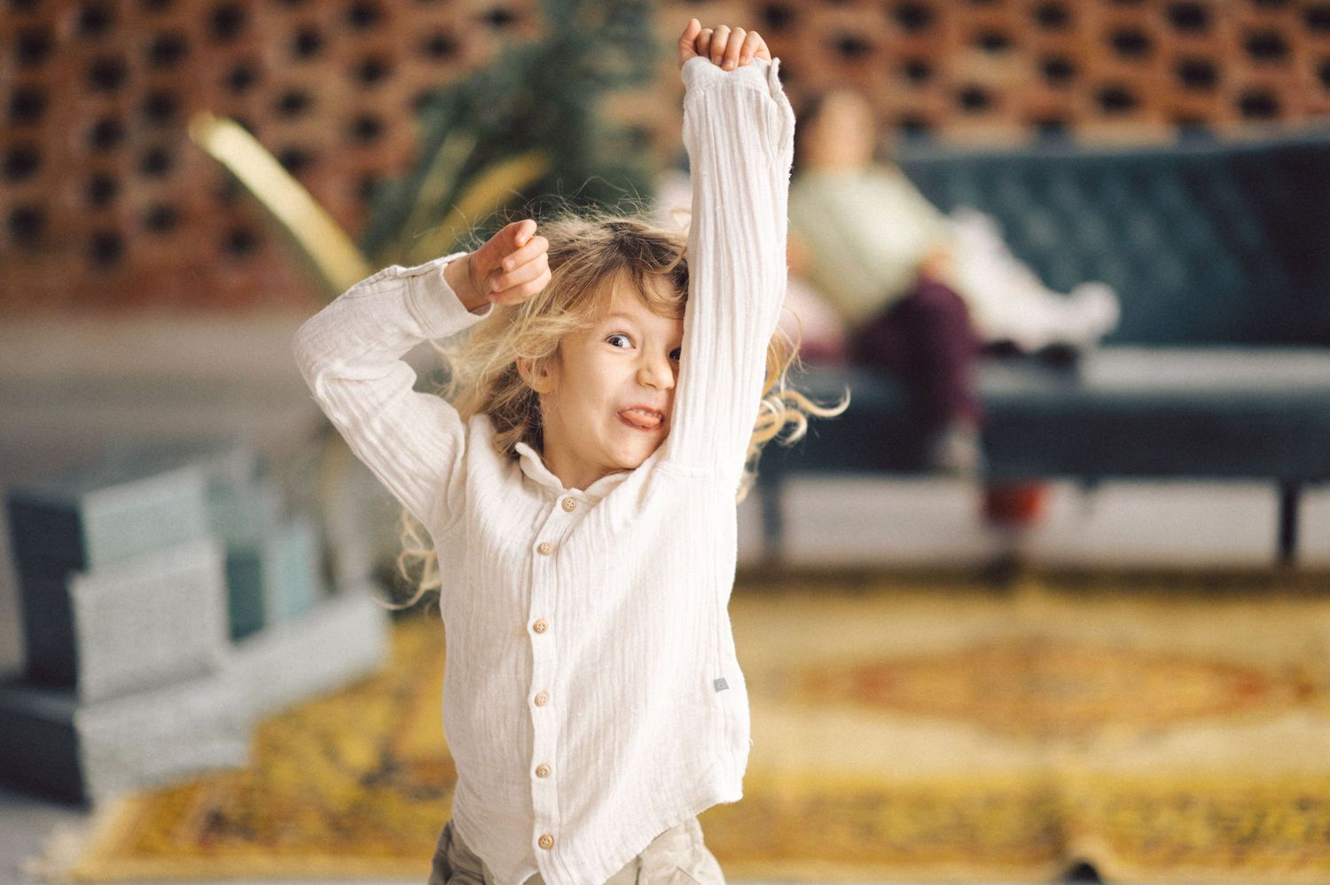 Figure skater performs graceful spiral on ice wearing white outfit during competitive performance.