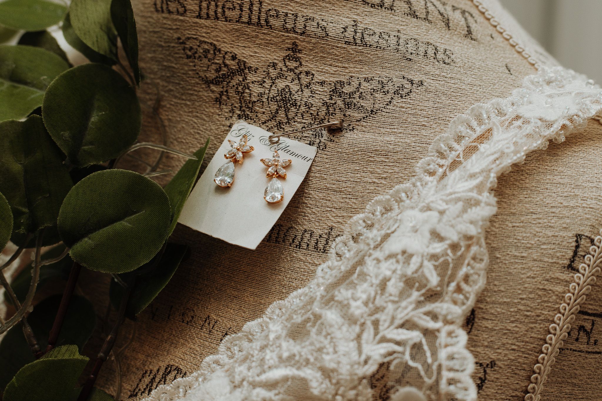 Vintage French text and lace details arranged in an elegant wedding flatlay.