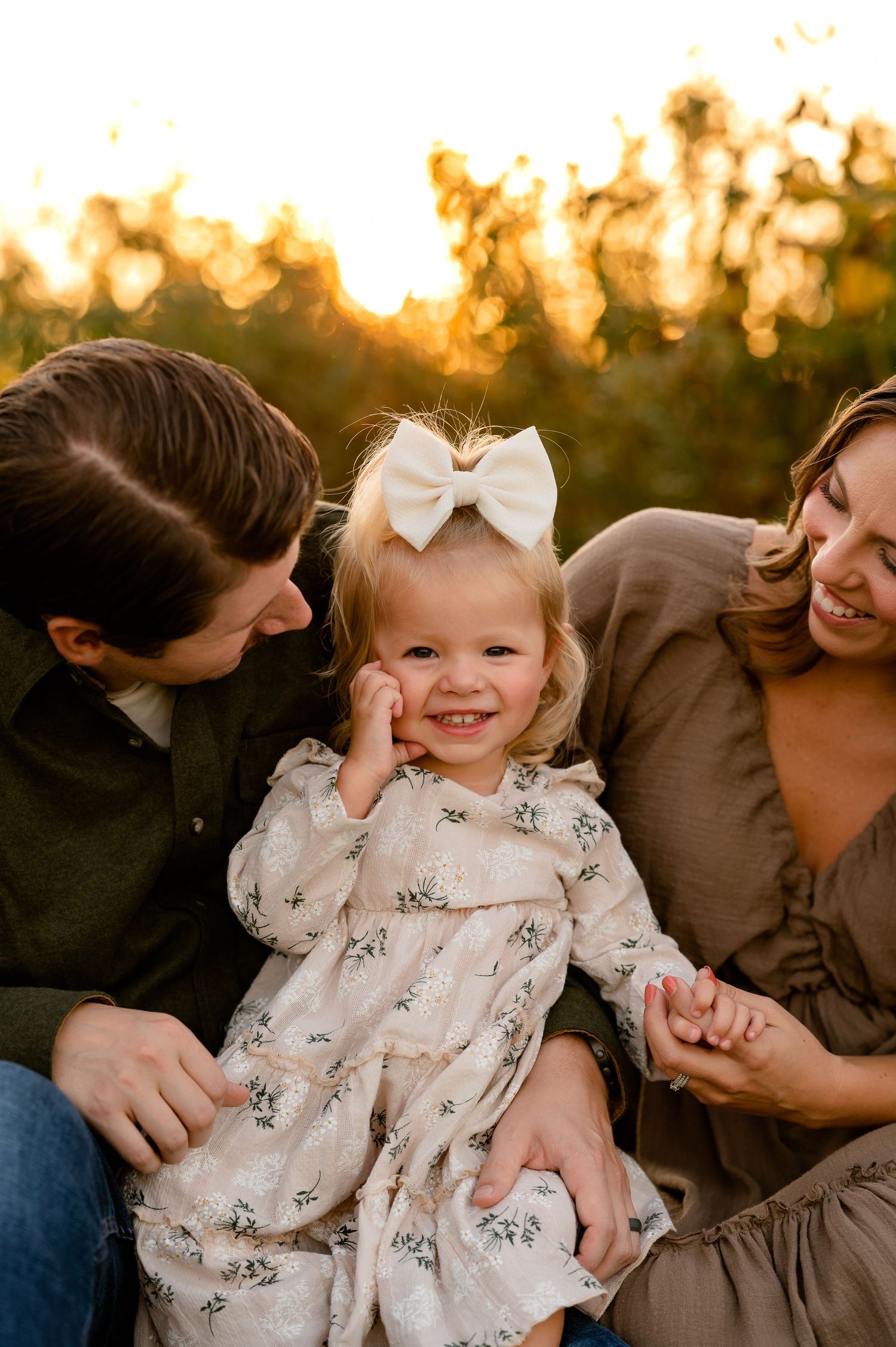 A candid family moment captured during golden hour with natural laughter created by Storms Photography in Pennsylvania.