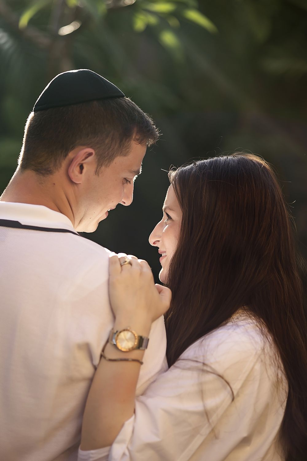 Close-up of couple smiling at each other during anniversary session at Banyan Tree Mayakoba.