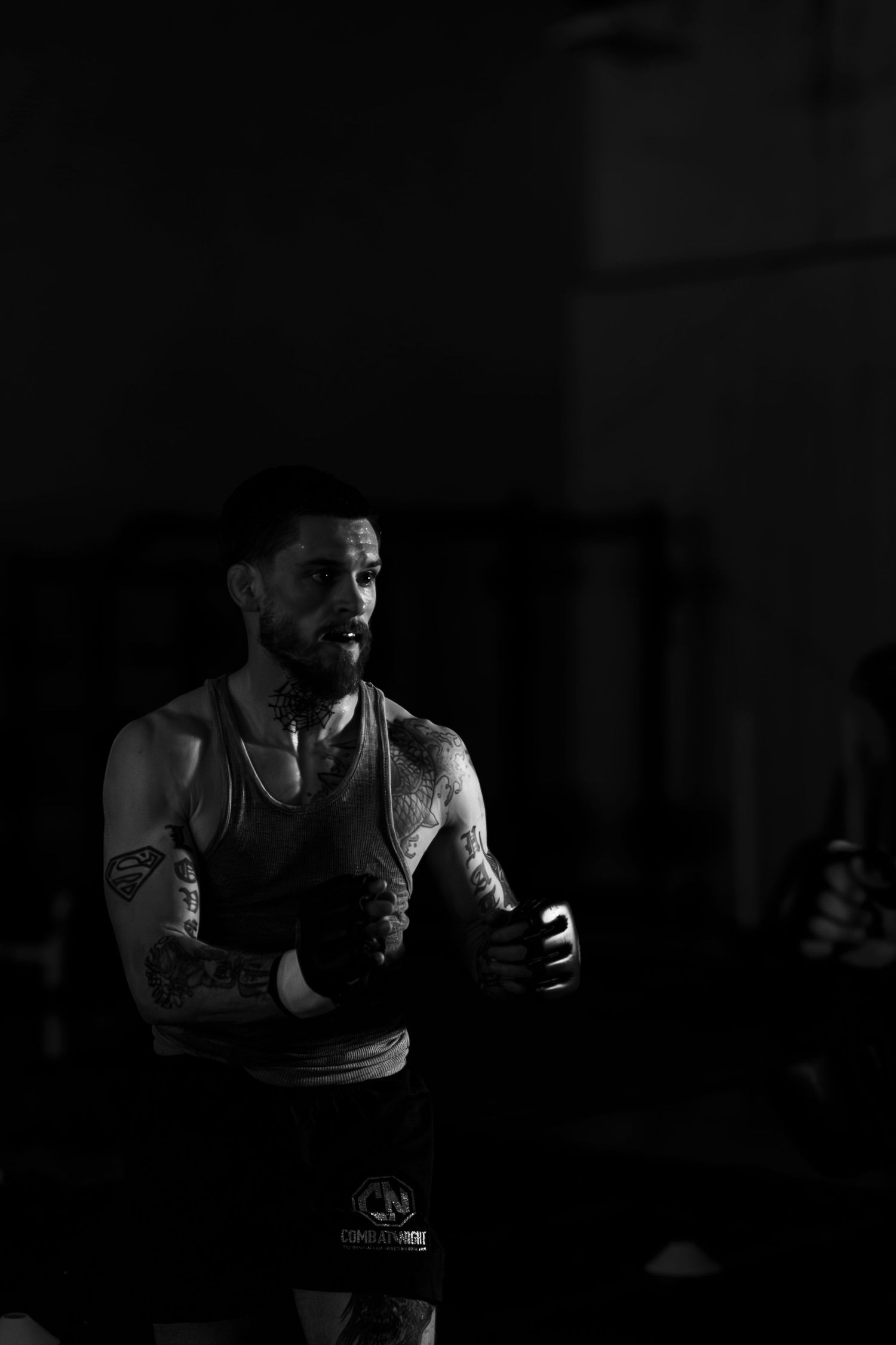 Dramatic black and white shot of athlete training in dim lighting.