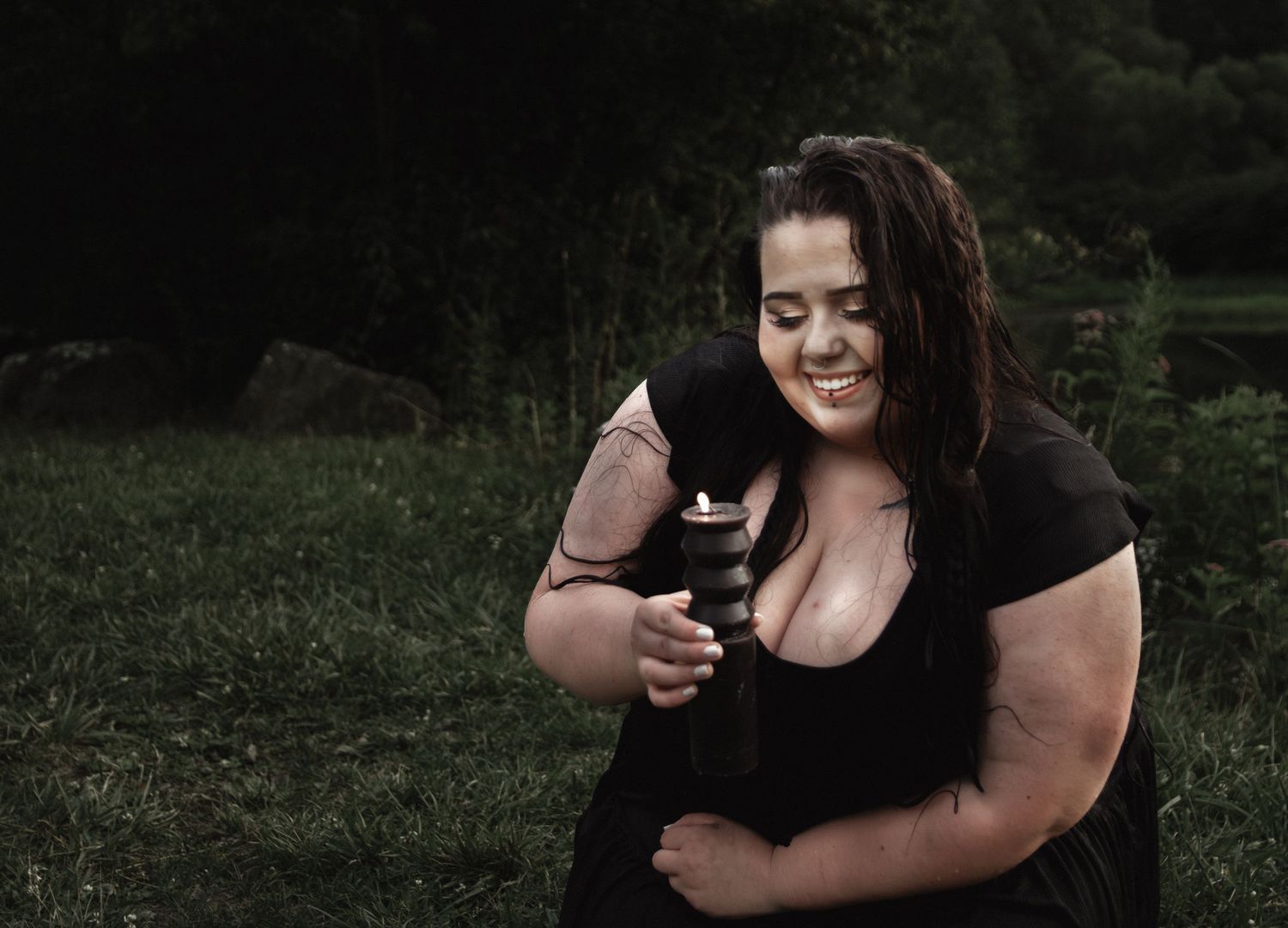 A candid moment captured outdoors showing someone in a black dress holding a small camera.