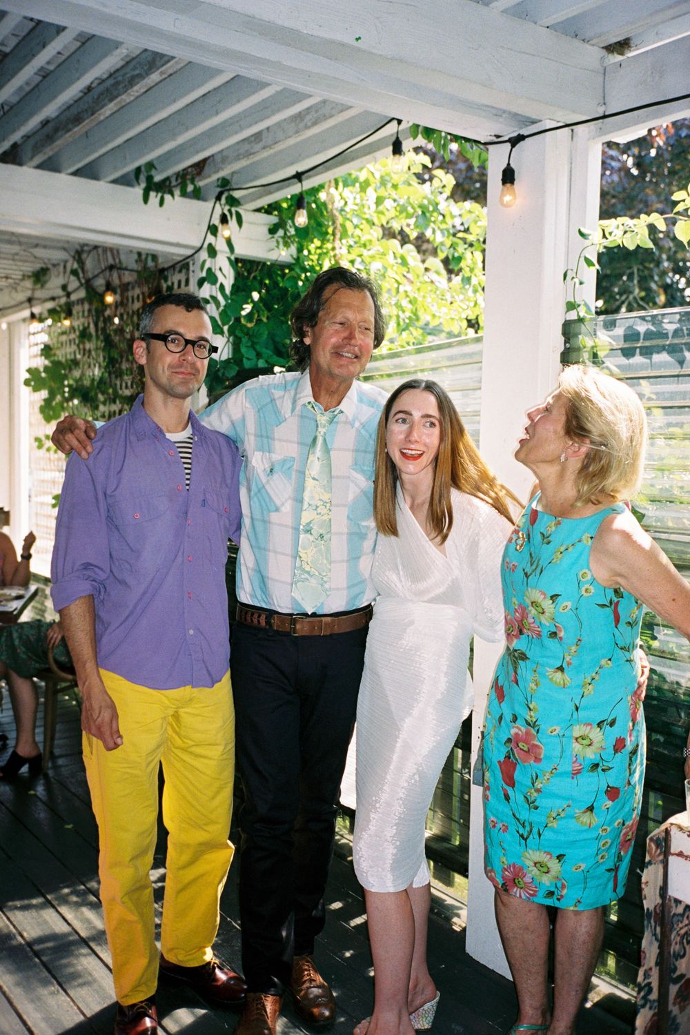 A candid and colorful photo of guests posing together in the afternoon sunshine at a bridal shower on 35mm film.