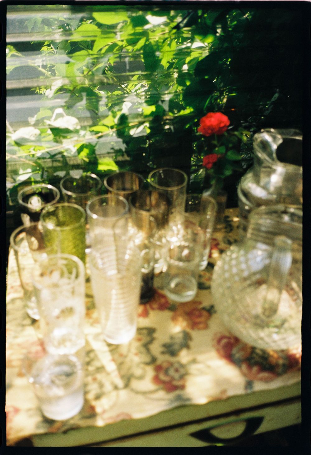 Detail photo of vintage glassware, pitchers and roses during a bridal shower at a wine bar in Brunswick, Maine.