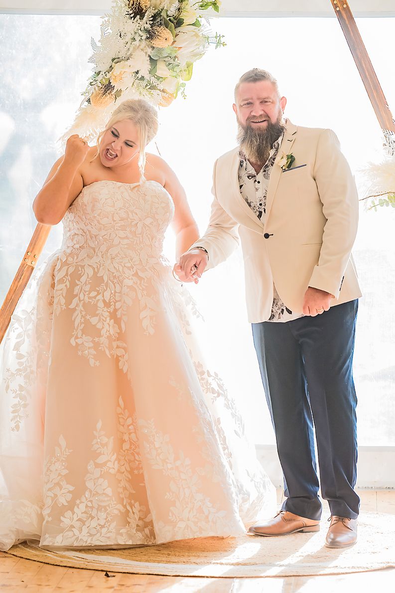 Wedding couple in white attire photographed in sequence walking together in bright indoor setting.