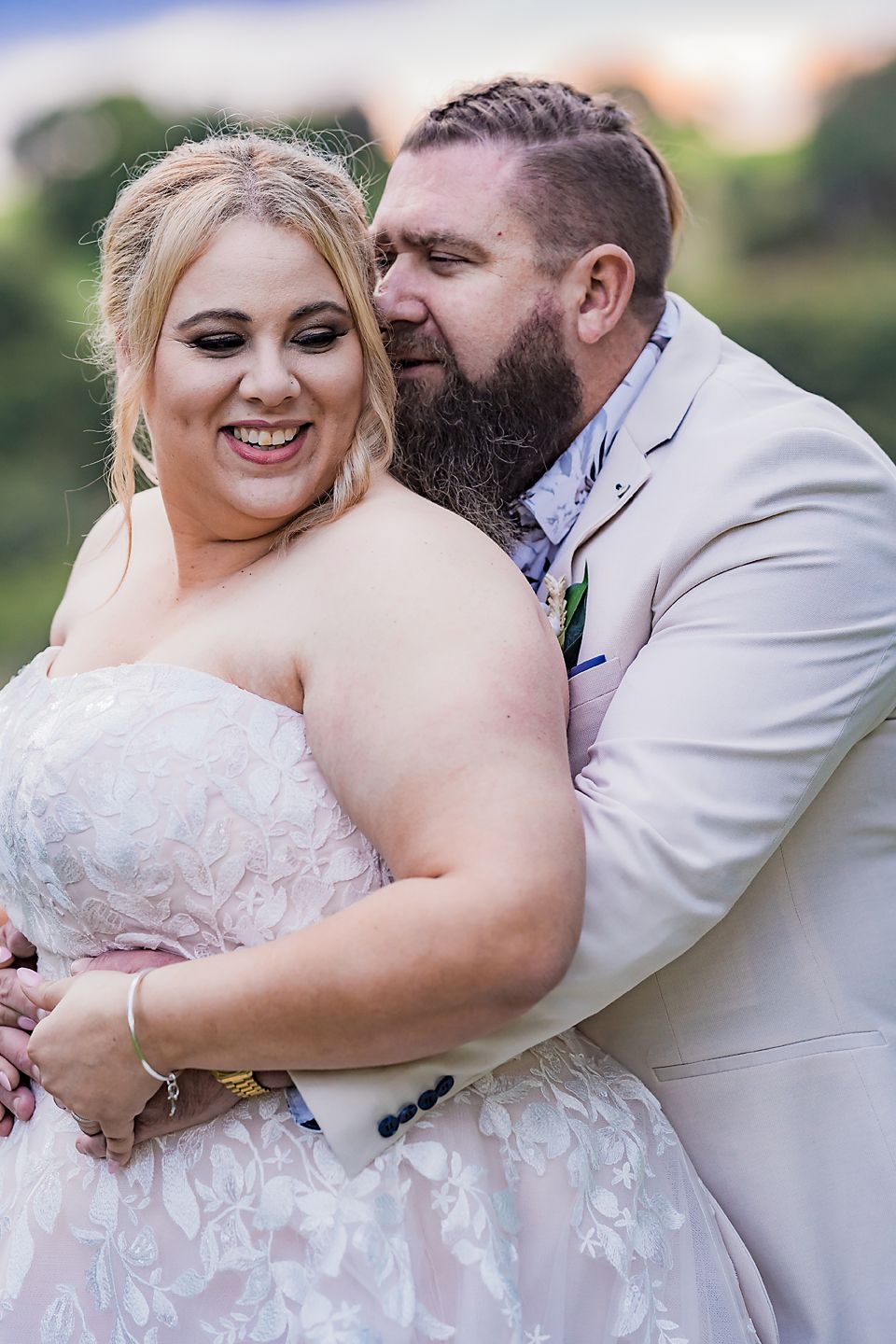 Intimate wedding portrait outdoors in natural lighting.