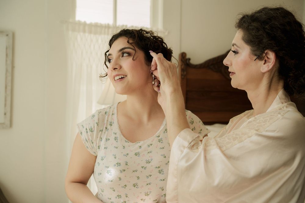 Wedding party getting ready in a bright indoor space with natural lighting.