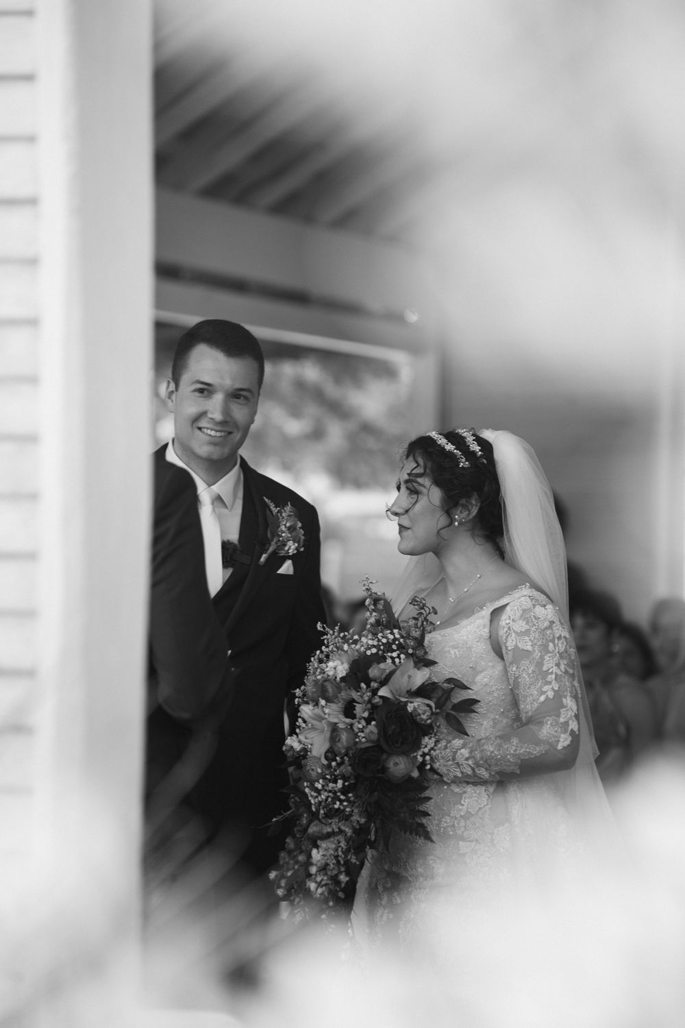 Black and white intimate portrait of newlyweds during their wedding ceremony.