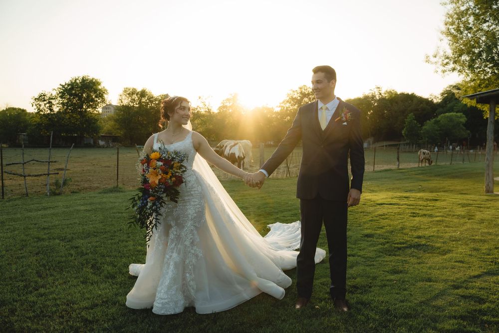 Romantic sunset wedding photos in a pastoral setting with flowing white dress.