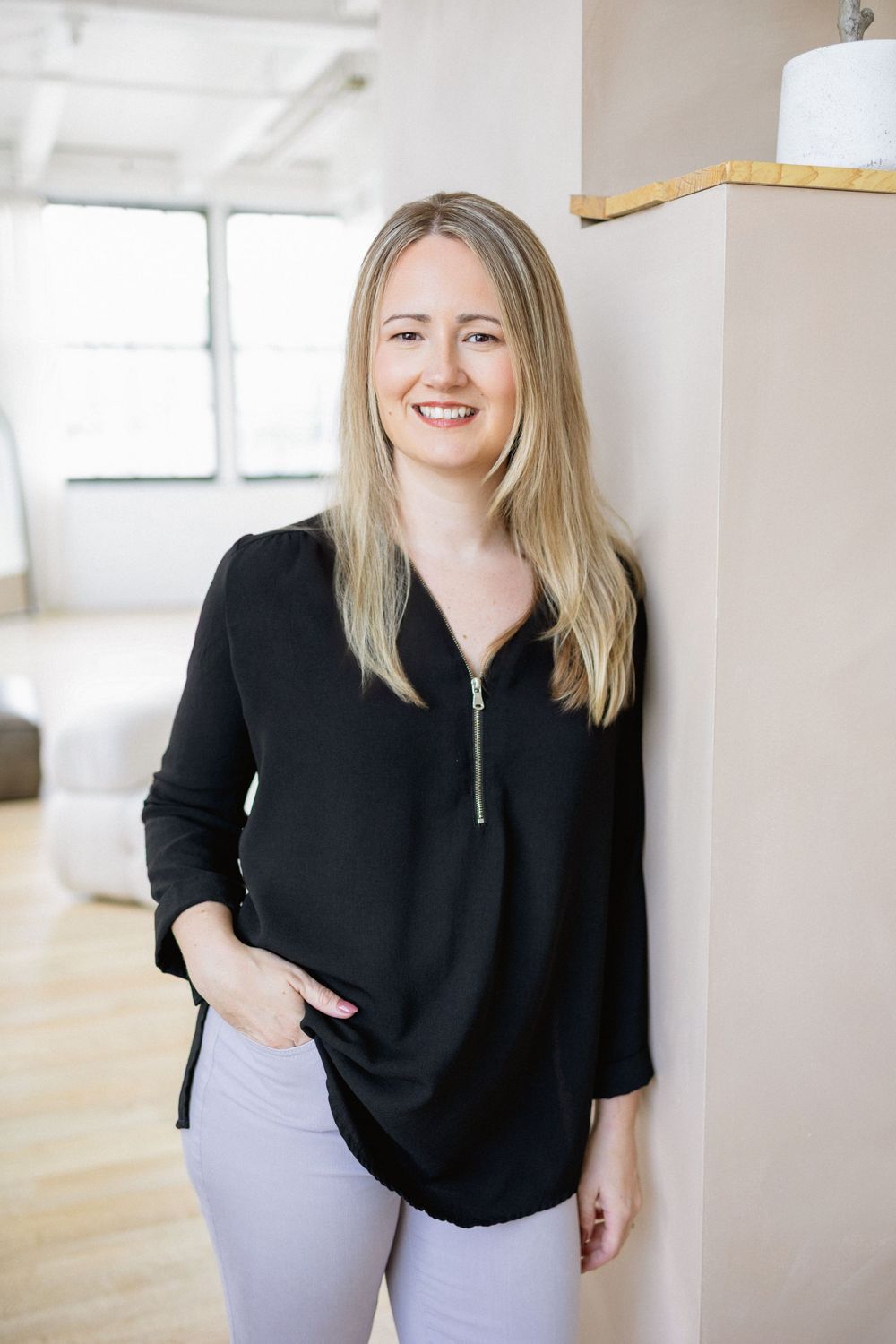 personal branding headshot session with a virtual therapist from Strathroy with casual black top, blond hair, and purple pastel pants