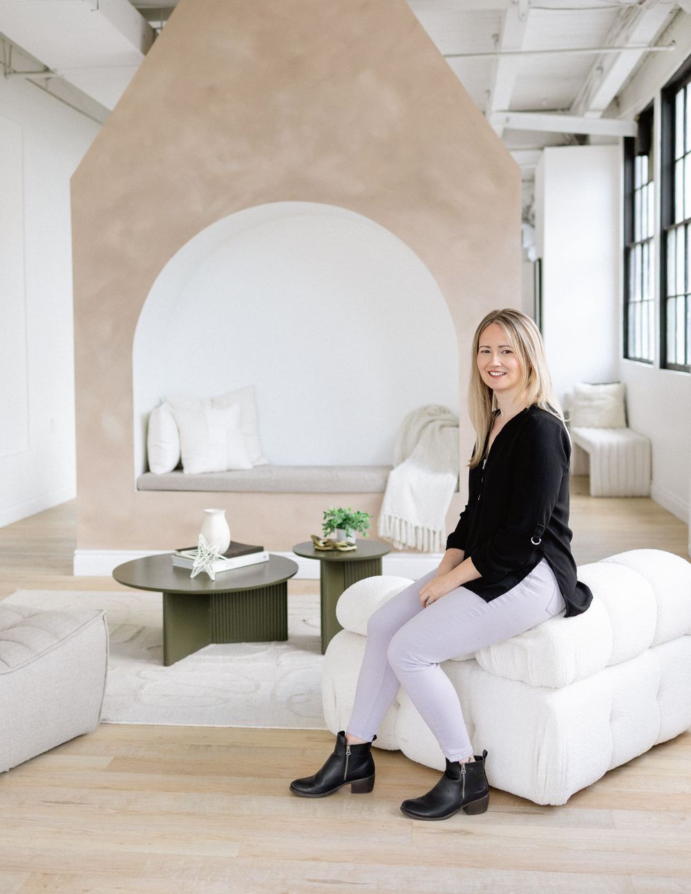 virtual therapist in Ontario during a branding photography session sitting on a white chair with purple pants and a casual black top