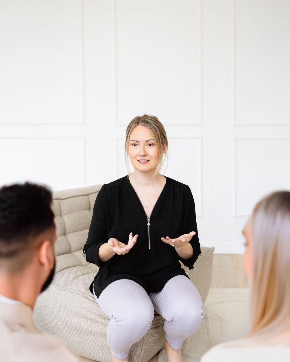 therapist doing an in person couples session with two people in the foreground